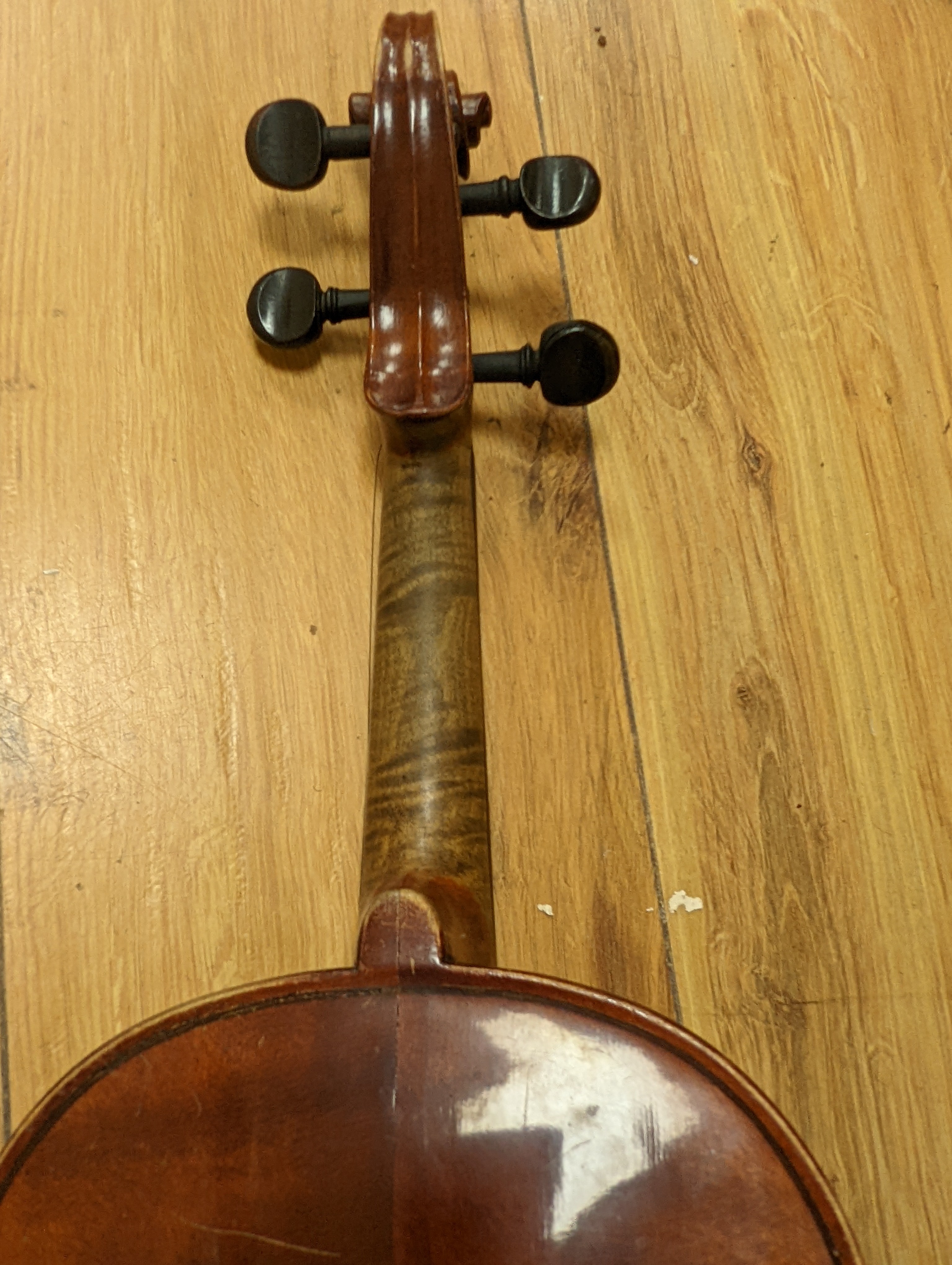 An early 20th century French vioilin, cased with bow and a cased saxon violin